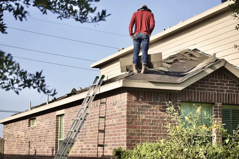Professional roofer working on a residential roof in Wilburton